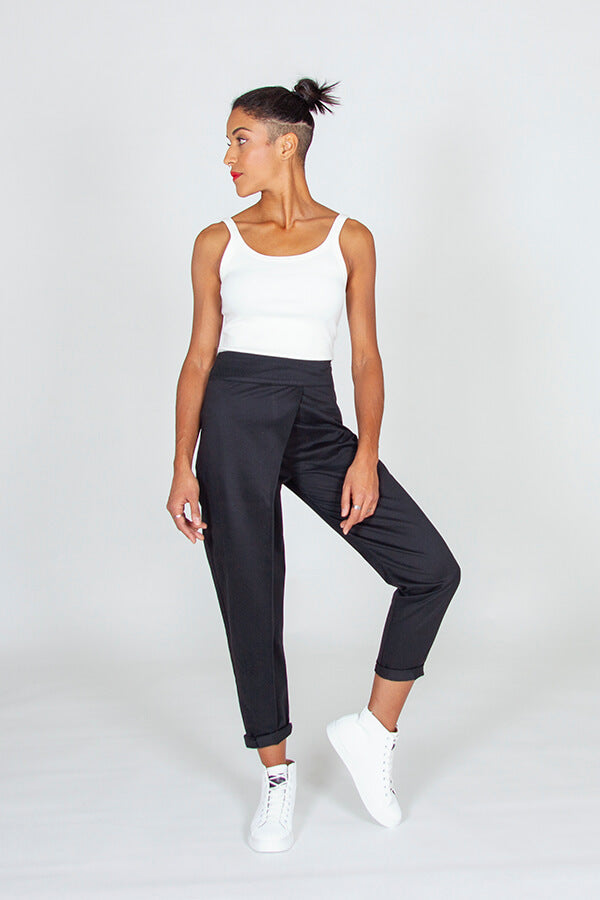 Woman wearing the Panoramix Trousers sewing pattern from I AM Patterns on The Fold Line. A trouser pattern made in lightweight denim, linen, wax, lightweight twill, lightweight gabardine, double gauze, lightweight jacquard, or wool blend fabrics, featurin