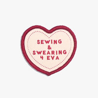 Photo of the ‘Sewing & Swearing 4 Eva’ iron-on patch from Kylie & The Machine on The Fold Line. An heart-shaped patch in red and pink ready to be attached to your handmade garment or bag.