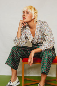 Woman wearing the Patina Blouse sewing pattern from Friday Pattern Company on The Fold Line. A blouse pattern made in light to mid weight woven fabrics, featuring a collared deep V-neck, button front closure and full length sleeves with cuffs.