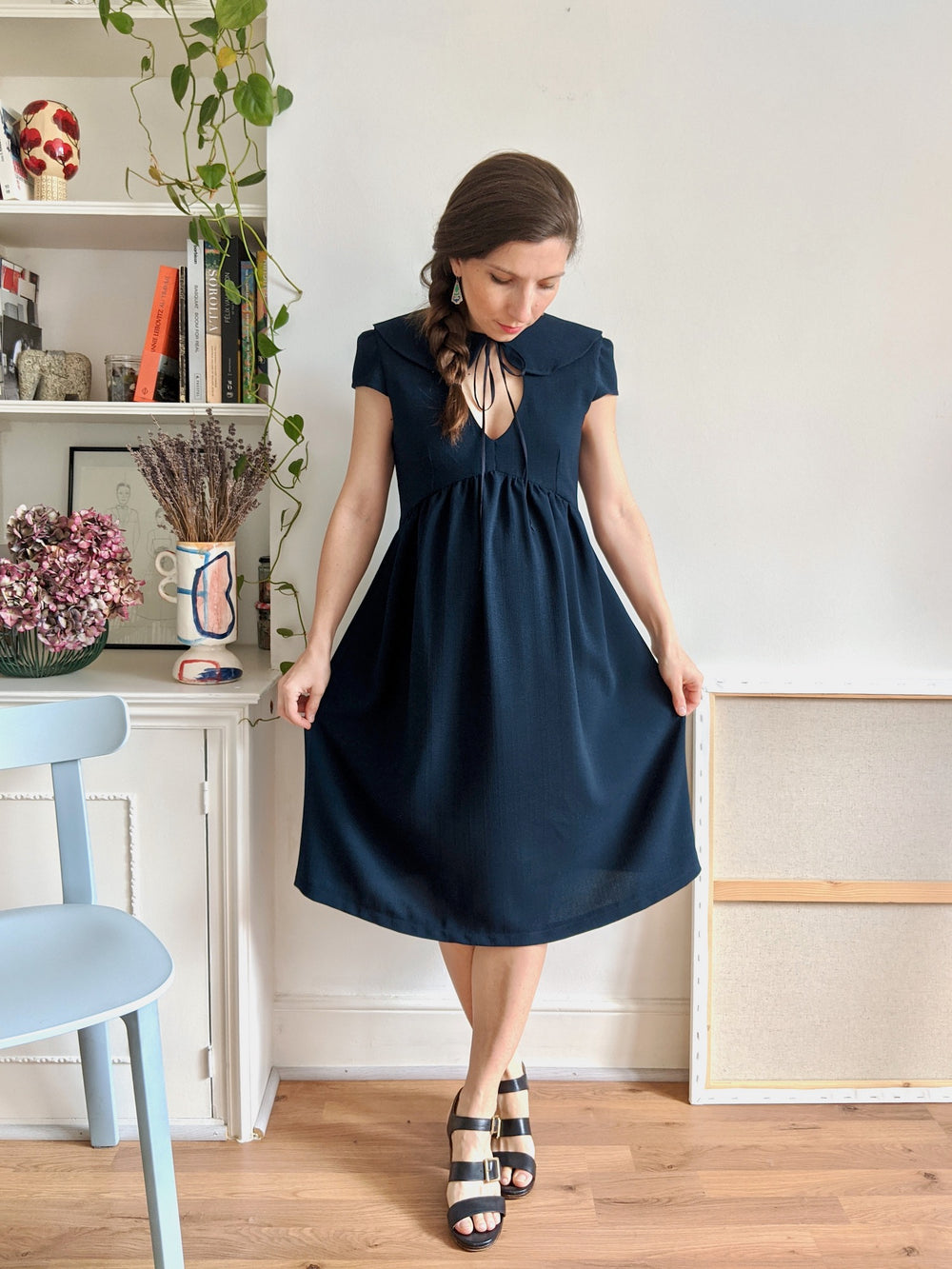 Woman wearing the Paulette Dress sewing pattern by Camimade. A dress pattern made in crepe, viscose, rayon, cotton lawn or cotton sateen fabrics, featuring a Peter Pan collar, front keyhole, cap sleeves and a gathered skirt that is pregnancy friendly due 