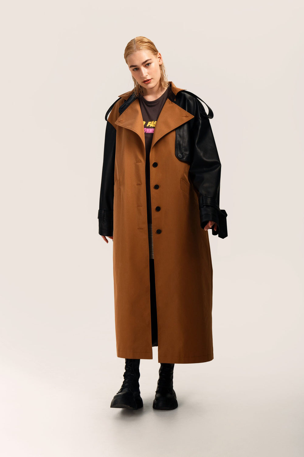 Woman wearing the Peyton Trench Coat sewing pattern from Vikisews on The Fold Line. An trench coat pattern made in cotton gabardine, corduroy, faux leather, or faux suede fabrics, featuring a loose-fit, straight-cut, lined, bust darts, front welt pockets,