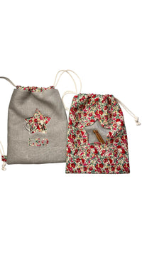 Photo showing the Phili Bag and Mini Backpack sewing pattern from Lasenby on The Fold Line. A backpack pattern made in canvas, linen, quilting cotton, twill, duck, denim, thin tweed, and Tana lawn fabrics, featuring a front star-shaped peekaboo pocket, le