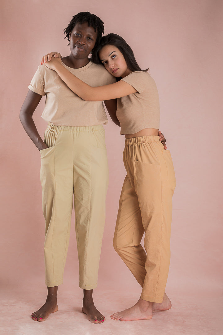 Women wearing the Pio Pants sewing pattern from Ready to Sew on The Fold Line. A trouser pattern made in cotton poplin, batik, linen, ramie or hemp canvas, light denim or light corduroy fabrics, featuring a relaxed fit, elasticated waist, slight carrot sh