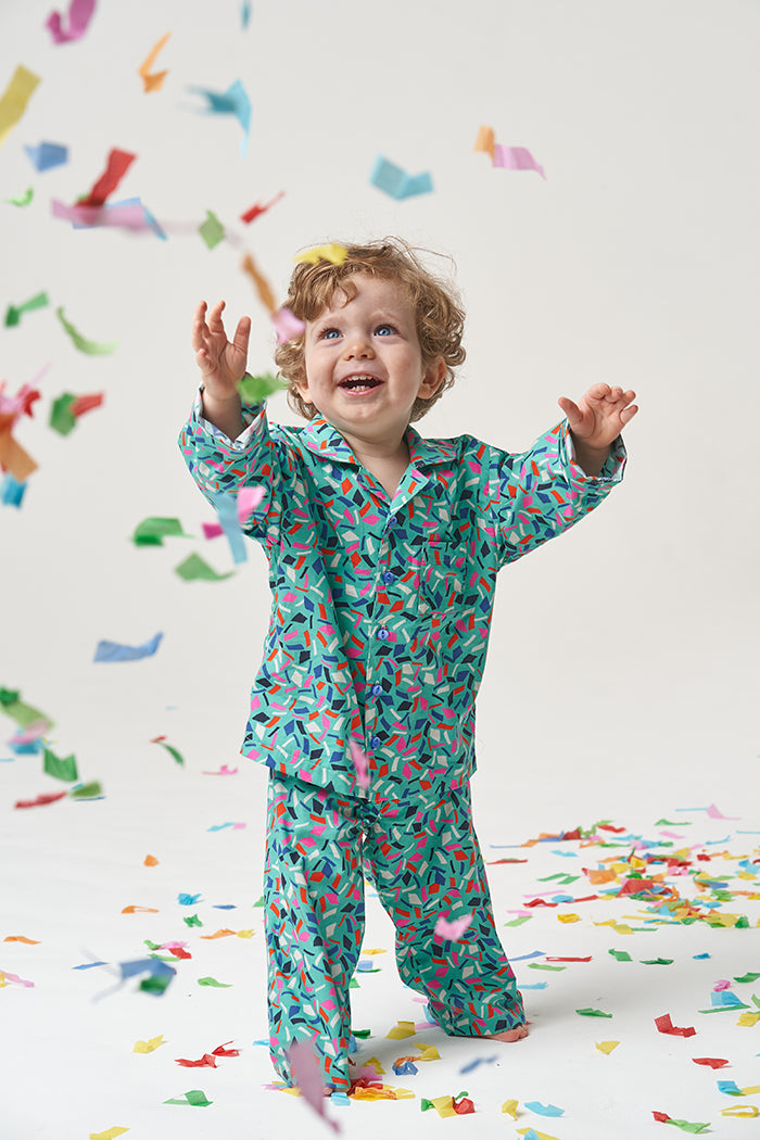 Child wearing the Baby/Child Pomegranate Pyjamas sewing pattern from Poppy & Jazz on The Fold Line. A pyjamas pattern made in viscose, cotton lawn, cotton poplin or quilting cottons fabrics, featuring a notched collar, button front, chest pocket, the bott