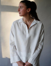 Woman wearing the Pull-on Shirt sewing pattern from The Maker's Atelier on The Fold Line. A shirt pattern made in cotton, linen, denim, chambray, Tencel or viscose fabrics, featuring a button-free placket, collar, back yoke, relaxed fit, full length sleev