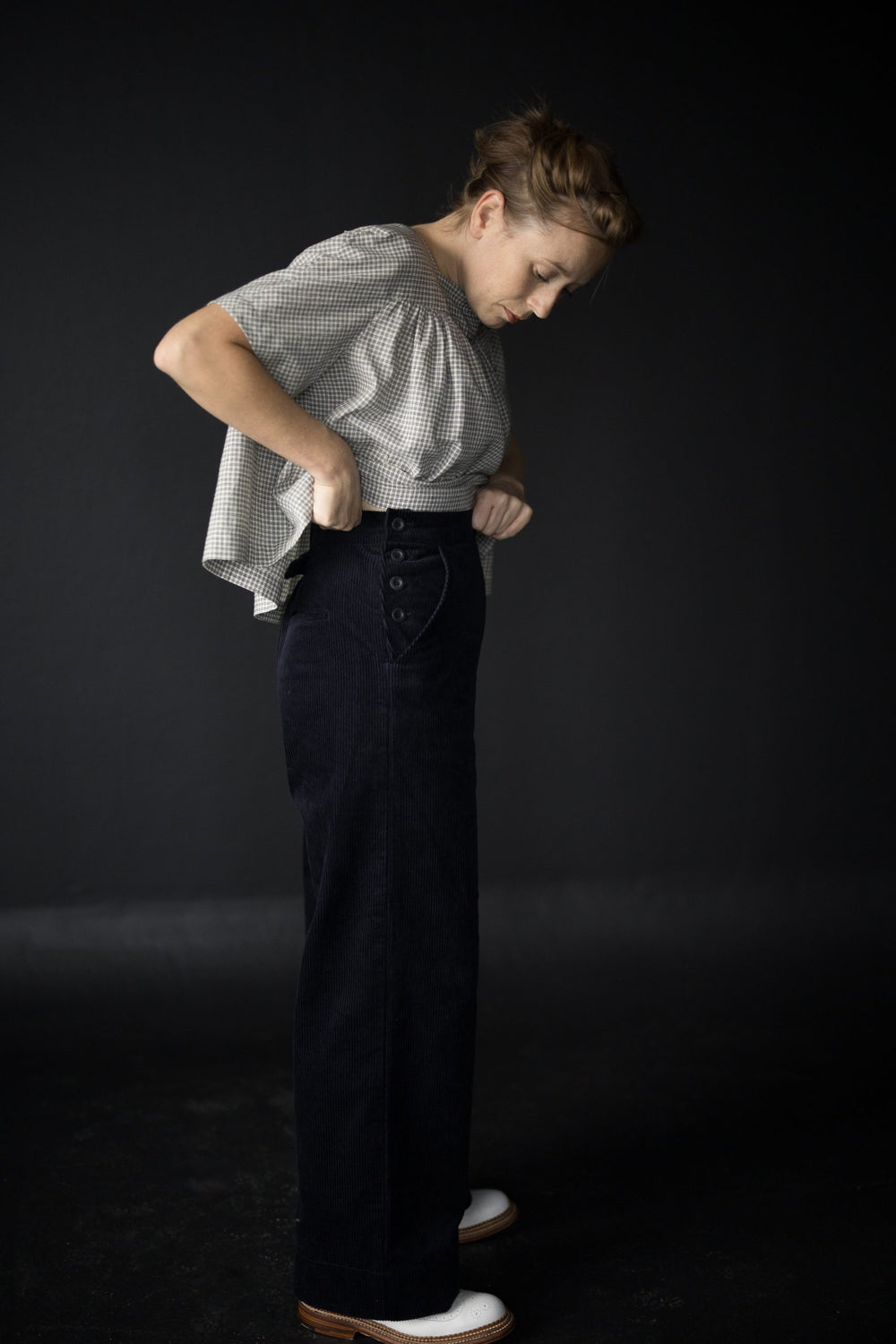 Woman wearing The Quinn Trousers sewing pattern from Merchant & Mills on The Fold Line. A trouser pattern made in cotton twill, denim, corduroy, light to medium weight woollens or linen fabrics, featuring full length wide legs, back welt pockets and front