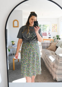 Woman wearing the Rachel Bias Skirt sewing pattern from Makyla Creates on The Fold Line. A skirt pattern made in sateen, linen, cotton, blends, poplin, silk, or rayon fabrics, featuring a bias cut, flute hemline, invisible side seam zipper and midi length