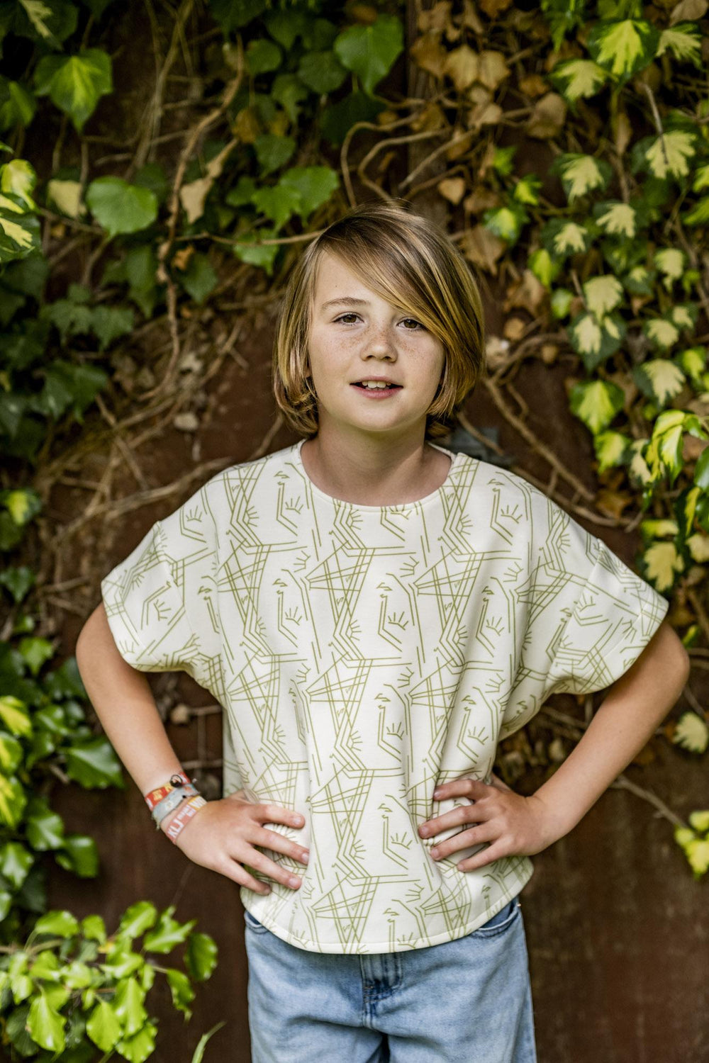 Child wearing the Children's Rae Top sewing pattern from Fibre Mood on The Fold Line. A top pattern made in interlock, single or double jersey, French terry, poplin, cotton voile, chambray, double gauze, or linen fabrics, featuring an oversized fit, round