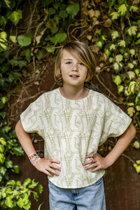 Child wearing the Children's Rae Top sewing pattern from Fibre Mood on The Fold Line. A top pattern made in interlock, single or double jersey, French terry, poplin, cotton voile, chambray, double gauze, or linen fabrics, featuring an oversized fit, round