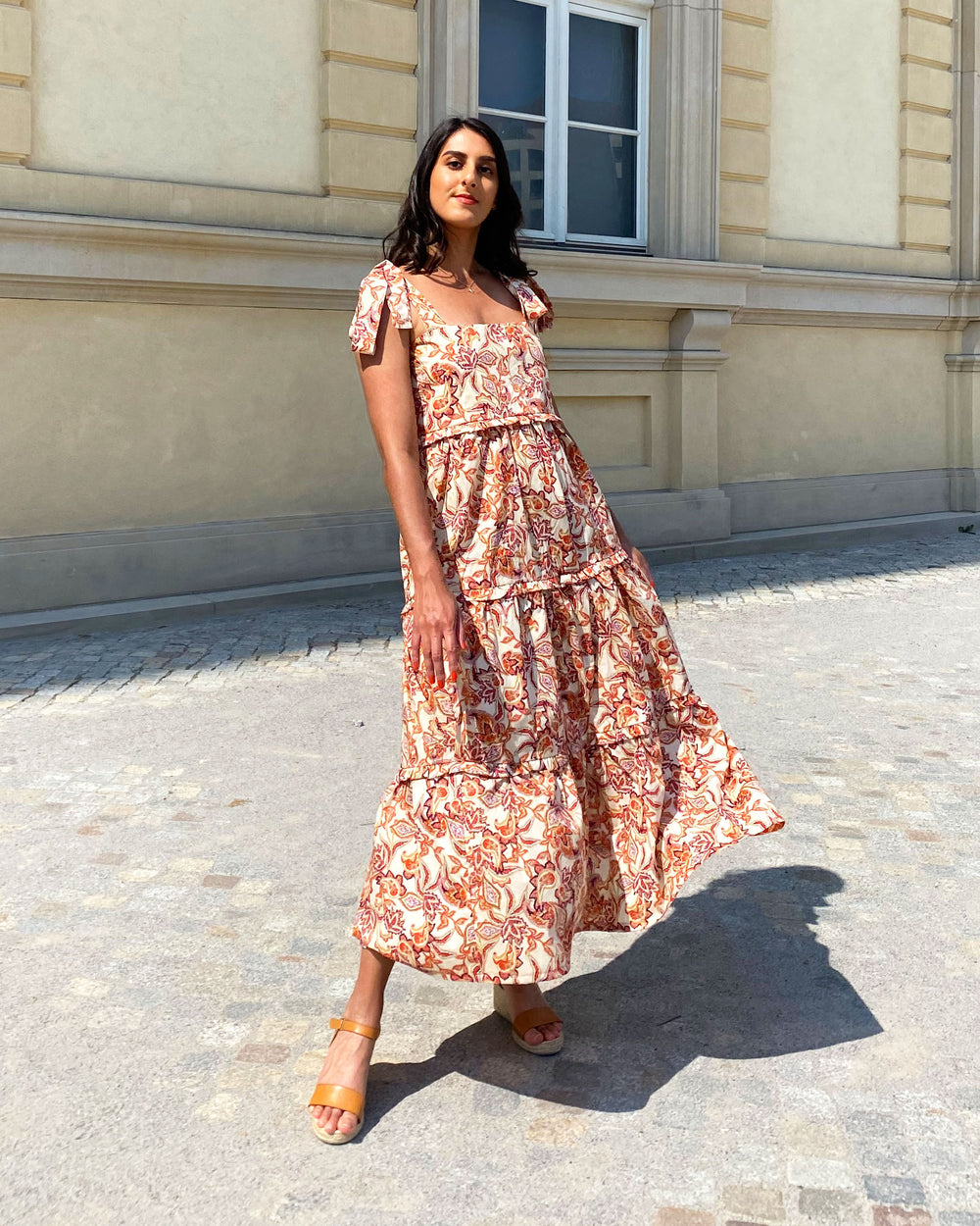 Woman wearing the Raman Dress sewing pattern from Tammy Handmade on The Fold Line. A slip-on dress pattern made in cotton, satin, cotton poplin, rayon/viscose, crepe or chiffon fabric, featuring long tie shoulder straps, square neckline, three-tiered skir