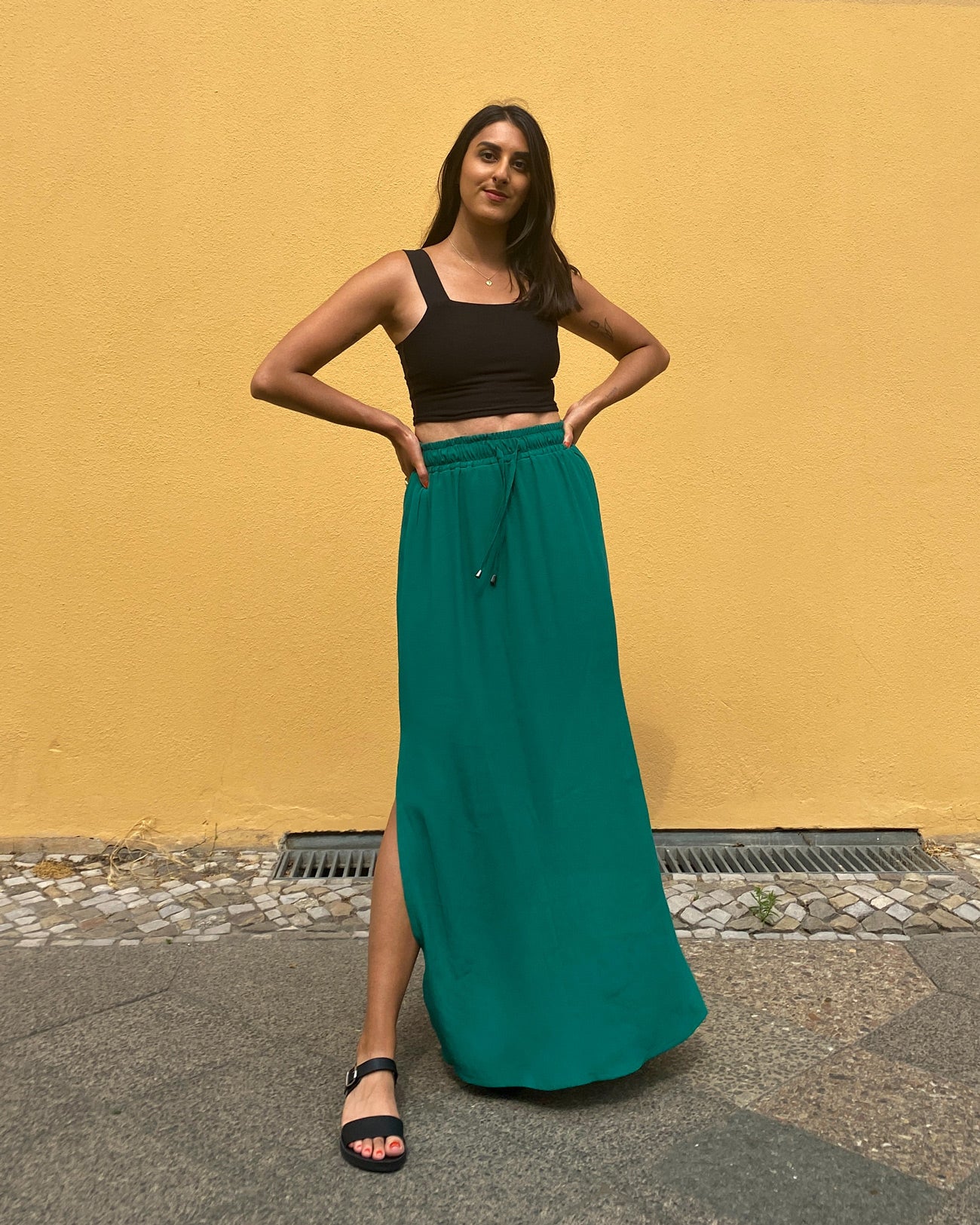 Woman wearing the Rani Skirt sewing pattern from Tammy Handmade on The Fold Line. A skirt pattern made in cotton, linen, viscose, rayon, satin or crepe fabrics, featuring a maxi length, side slits, slip-on style and elasticated drawstring waist.