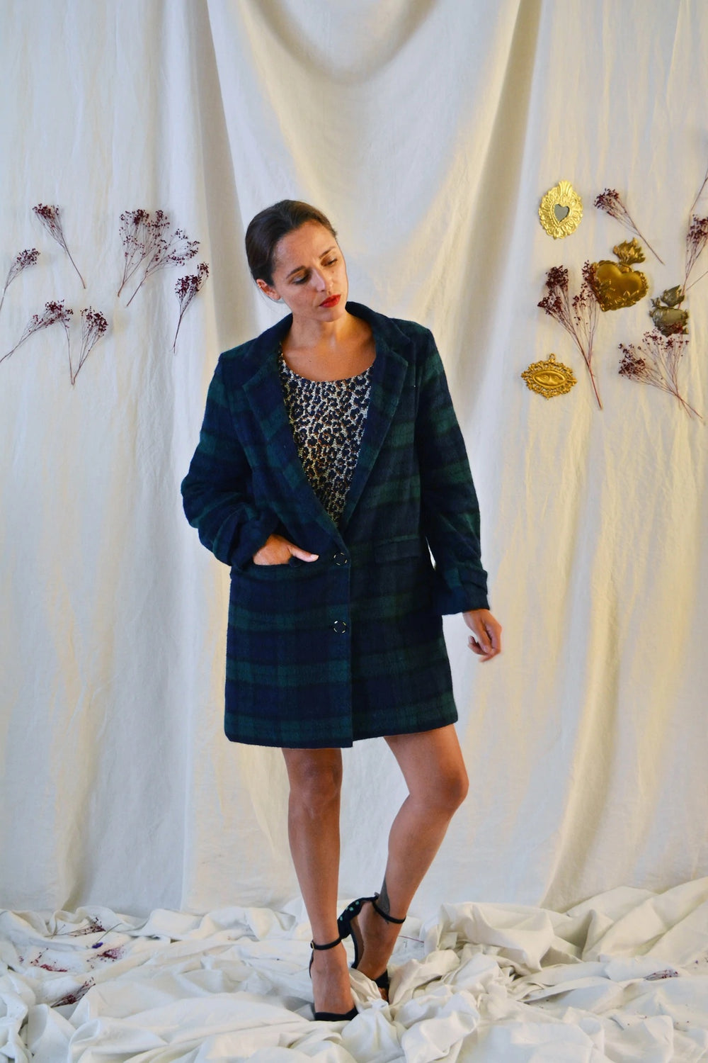 Woman wearing the Ray Coat sewing pattern from Maison Fauve on The Fold Line. A coat pattern made in wool, Jacquard or velvet fabrics, featuring a lowered button fastening, piped pockets with flaps, folded sleeve with buttoned strap, collar extending into