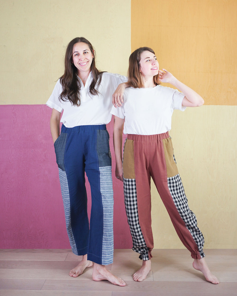 Women wearing the Recess Play Pants sewing pattern from Matchy Matchy on The Fold Line. A trouser pattern made in medium weight woven fabrics, featuring a relaxed fit, elasticated waistband, slant front pockets, back patch pockets, patchwork design, high-
