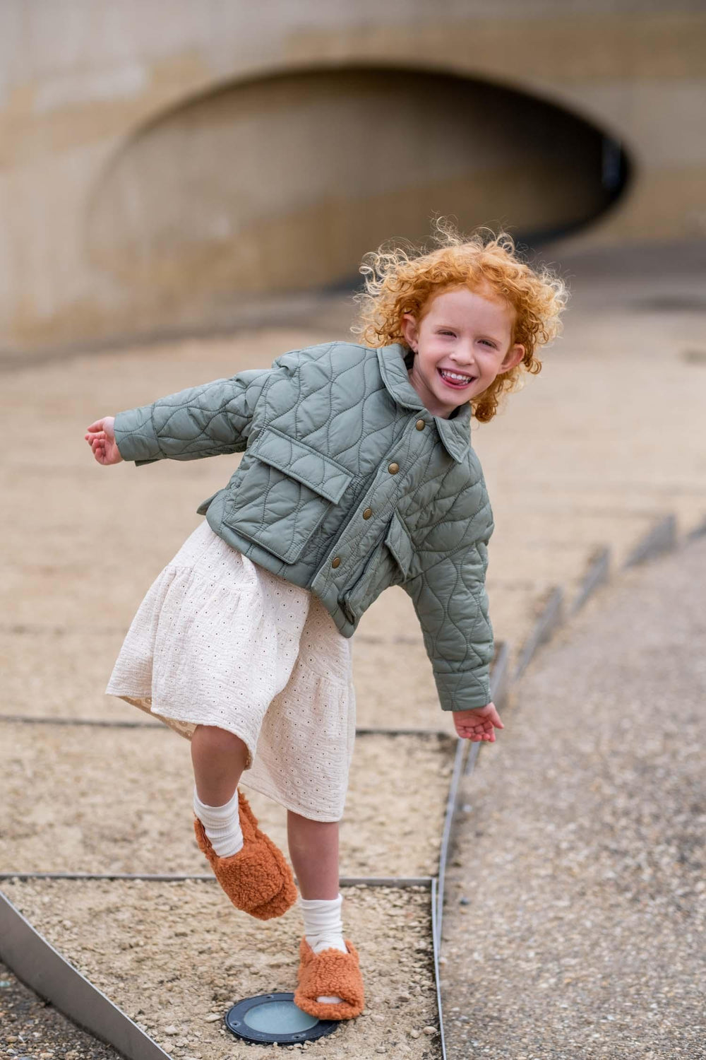 Child wearing the Child/Teen Reese Coat sewing pattern from Fibre Mood on The Fold Line. A unisex coat pattern made in padded, quilted, matelassé, Teddy, woollens, leatherette, denim, corduroy or velvet fabrics, featuring an unlined boxy oversized silhoue