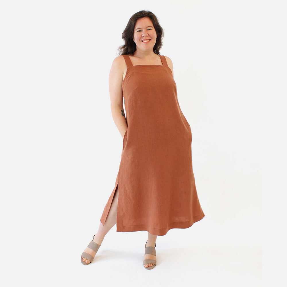 Woman wearing the Reynolds Dress sewing pattern from Helens Closet on The Fold Line. A sundress pattern made in linen, cottons, Tencel twill, silk, rayon/viscose challis or poplin fabrics, featuring wide shoulder straps, bust darts, in-seam pockets, side 