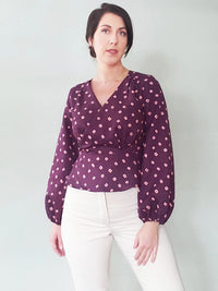 Woman wearing the Romy Wrap Expansion Pack sewing pattern from Pattern Scout on The Fold Line. A top pattern made in tencel, lyocell, rayon, crepe de chine, linen, chambray, poplin, or voile fabric, featuring a v-neck, wrap front, and full-length bishop s