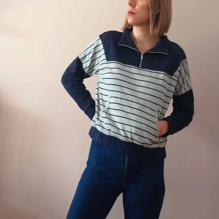 Woman wearing the Roscoe Sweater sewing pattern from French Navy on The Fold Line. A sweater pattern made in cotton fleece, polar fleece, french terry, or cotton velour fabrics, featuring a boxy fit, zipped front yoke, funnel neck, dropped sleeves, kangar