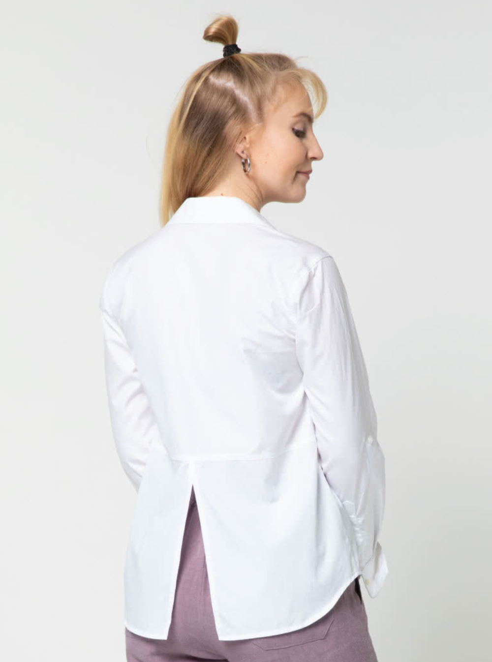 Woman wearing the Roxy Woven Shirt sewing pattern from Style Arc on The Fold Line. A shirt pattern made in linen, cotton or silk blends fabrics, featuring a button front closure, slightly dropped shoulder, two-piece collar, bust dart from the armhole, lon