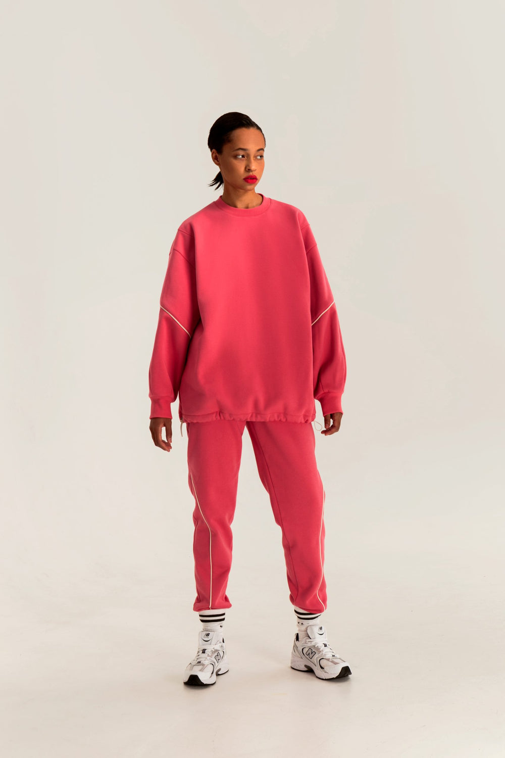 Woman wearing the Roxy Sweatshirt sewing pattern from Vikisews on The Fold Line. A sweatshirt pattern made in heavyweight sweatshirt fleece fabrics, featuring an oversized straight silhouette, shoulder darts, round neckline with ribbed neckband, full-leng