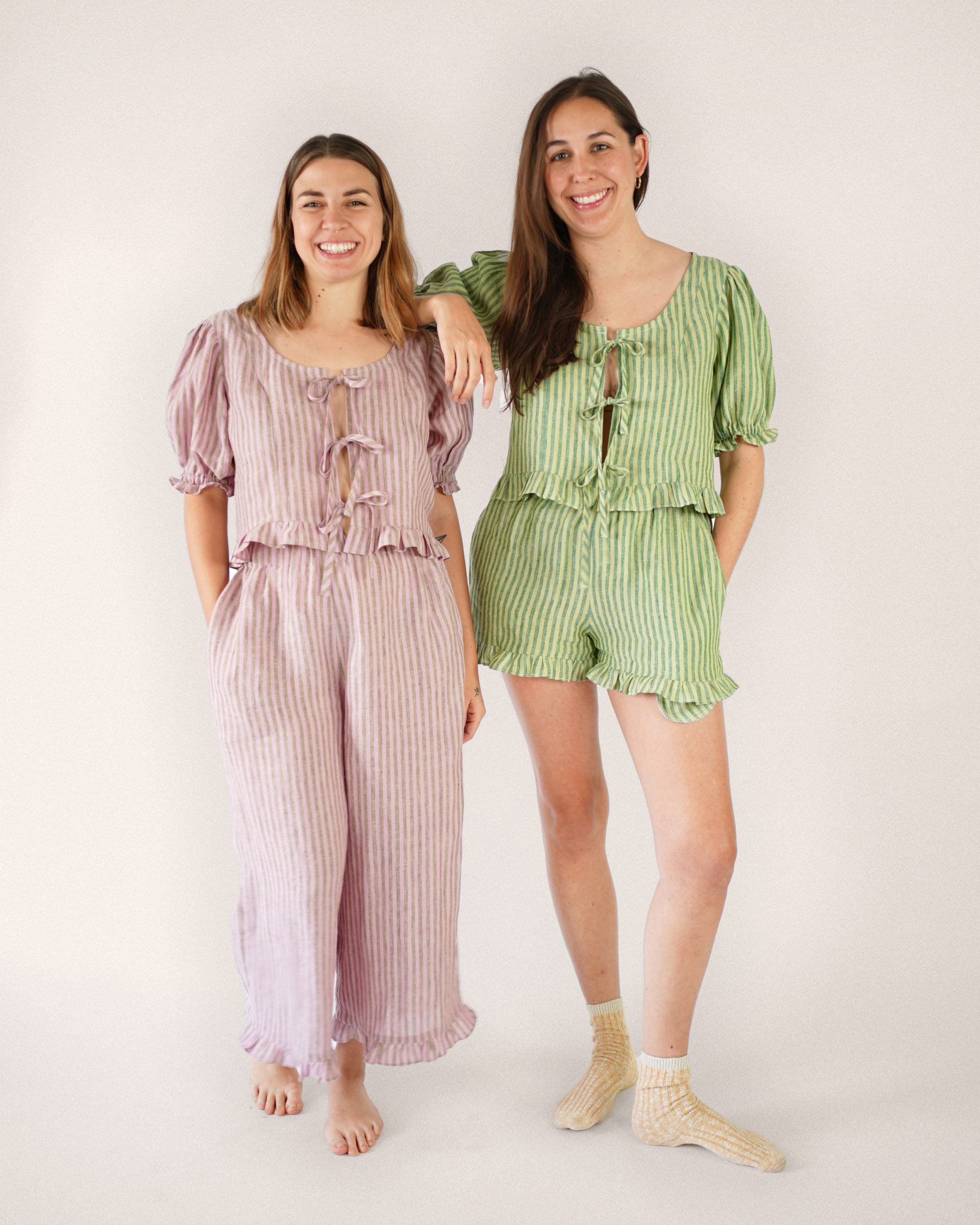 Women wearing the Ruffle Brunch Set sewing pattern from Matchy Matchy Sewing Club on The Fold Line. A two-piece set pattern made in linen, cotton, or rayon fabric, featuring a slightly cropped top with a wide scooped neckline, princess seams, puffed sleev