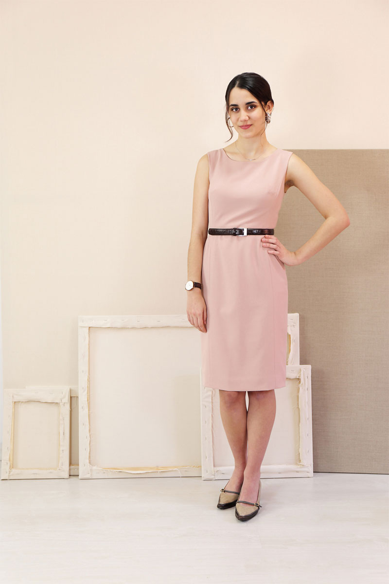 Woman wearing the Rush Hour Dress sewing pattern from Liesl + Co on The Fold Line. A dress pattern made in wool crepe, wool flannel, linen, denim or twill fabrics, featuring princess seams, sleeveless, pencil skirt with back walking vent, invisible back z