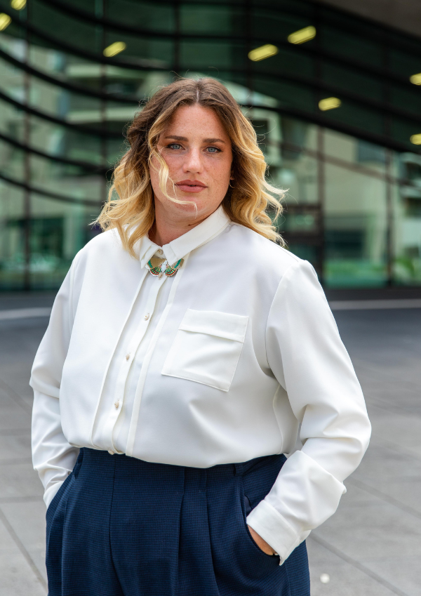 Woman wearing the Skyline Shirt sewing pattern from Maison Fauve on The Fold Line. A shirt pattern made in poplin, voile, crepe, cotton, tencel, viscose, linen, very fine denim or light velvet fabrics, featuring a straight cut, stitched pleats on the fron