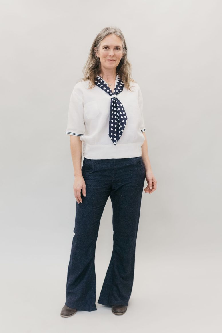 Woman wearing the 229 Unisex Sailor Pants sewing pattern from Folkwear on The Fold Line. A trouser pattern made in wool melton, denim, twill, cotton duck, linen, flannel, or light to medium weight canvas fabrics, featuring a high-waisted, bell bottom legs