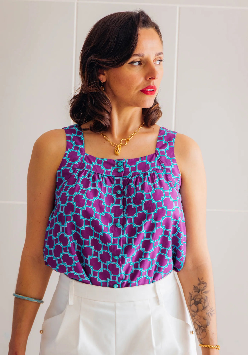Woman wearing the Salto Top sewing pattern from Maison Fauve on The Fold Line. A top pattern made in cotton, viscose poplin, jacquard, viscose crepe, twills, tencel, or broderie anglaise fabrics, featuring a square neckline, sleeveless, broad shoulder str