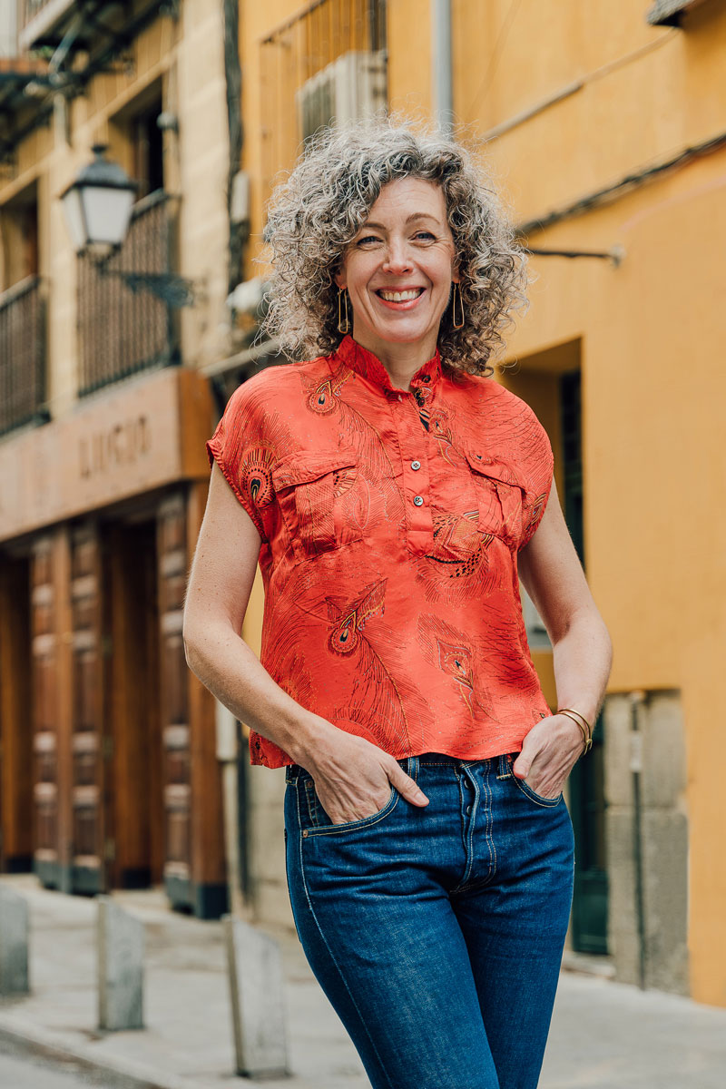 Woman wearing the Santa Rosa Top sewing pattern from Liesl + Co on The Fold Line. A top pattern made in rayon, poly satin, silk satin and crepe fabrics, featuring a band collar, popover button placket, short dolman sleeves, relaxed fit, dropped shoulders,