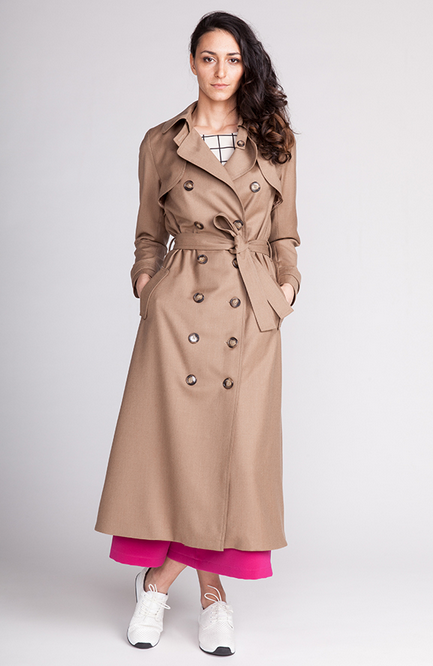 Woman wearing the Isla Trench Coat sewing pattern from Named on The Fold Line. A coat pattern made in gabardine or cotton twill fabrics, featuring a straight cut, fully lined, belted collar, attached cape, welt pockets, belt, sleeve, back vent, double-bre