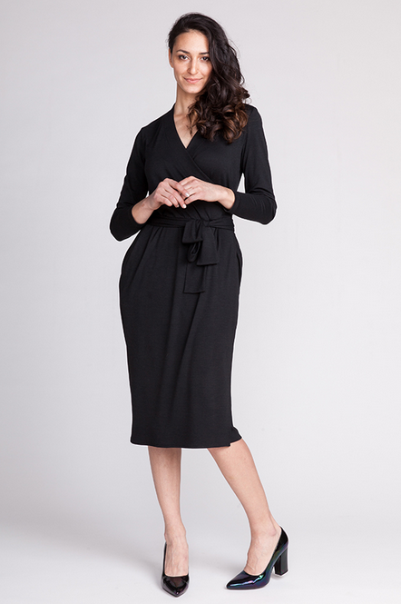 Woman wearing the Olivia Wrap Dress sewing pattern from Named on The Fold Line. A wrap dress pattern made in light weight or medium weight drapey jersey fabrics, featuring a tulip shaped skirt, front waist pleats, side seam pockets, elasticated waist, wid