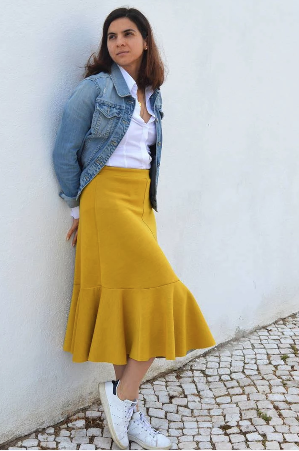 Woman wearing the Linea A-Line Skirt sewing pattern from Wardrobe by Me on The Fold Line. A skirt pattern made in light to medium weight knit jersey fabrics, featuring a four gored skirt, elasticated waist, midi length hem and circular voilant sewn to the
