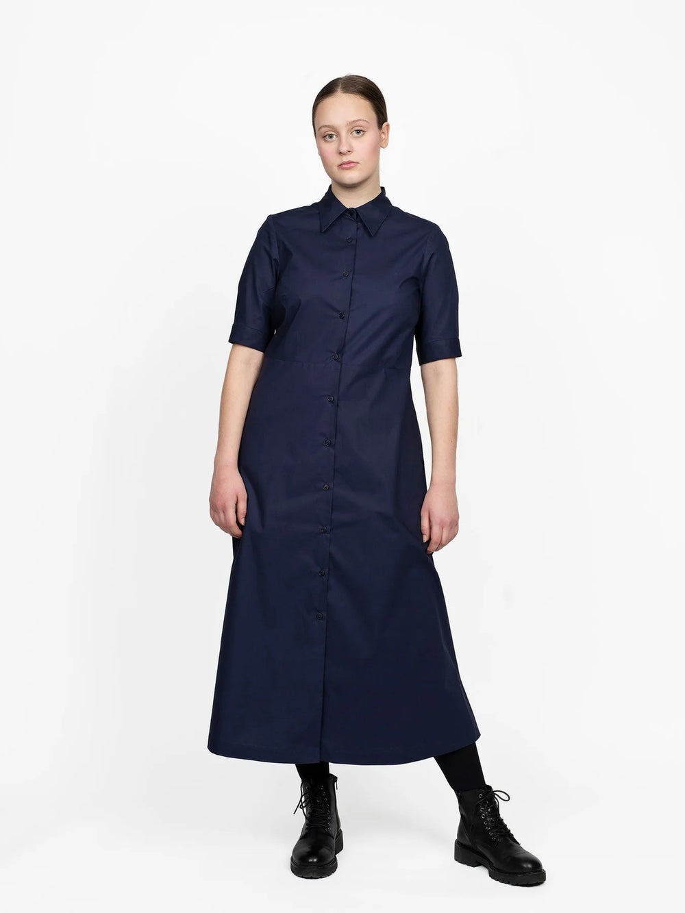 Woman wearing the Shirt Dress sewing pattern from The Assembly Line on The Fold Line. A shirt dress pattern made in cotton, tencel, silk, lawn, linen, crepe de chine or wool crepe fabrics, featuring a slight A-line silhouette, mid-calf length, regular col