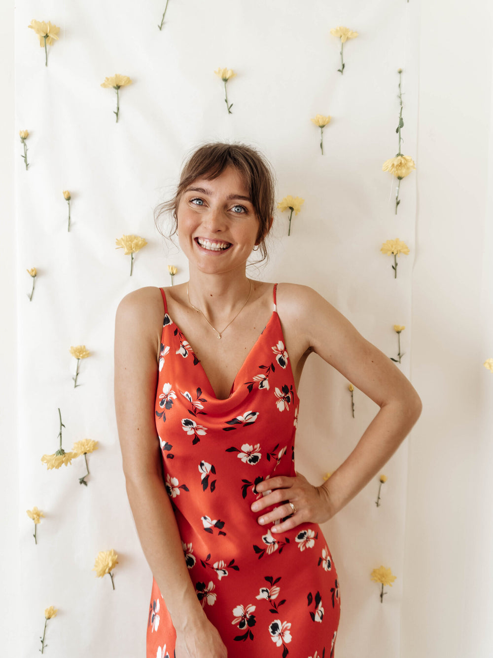 Woman wearing the Sicily Slip Dress sewing pattern from Sewing Patterns by Masin on The Fold Line. A sleeveless, slip dress pattern made in satins, lightweight crepes, rayon/viscose, chiffon or charmeuse fabrics, featuring a bias cut, narrow shoulder stra