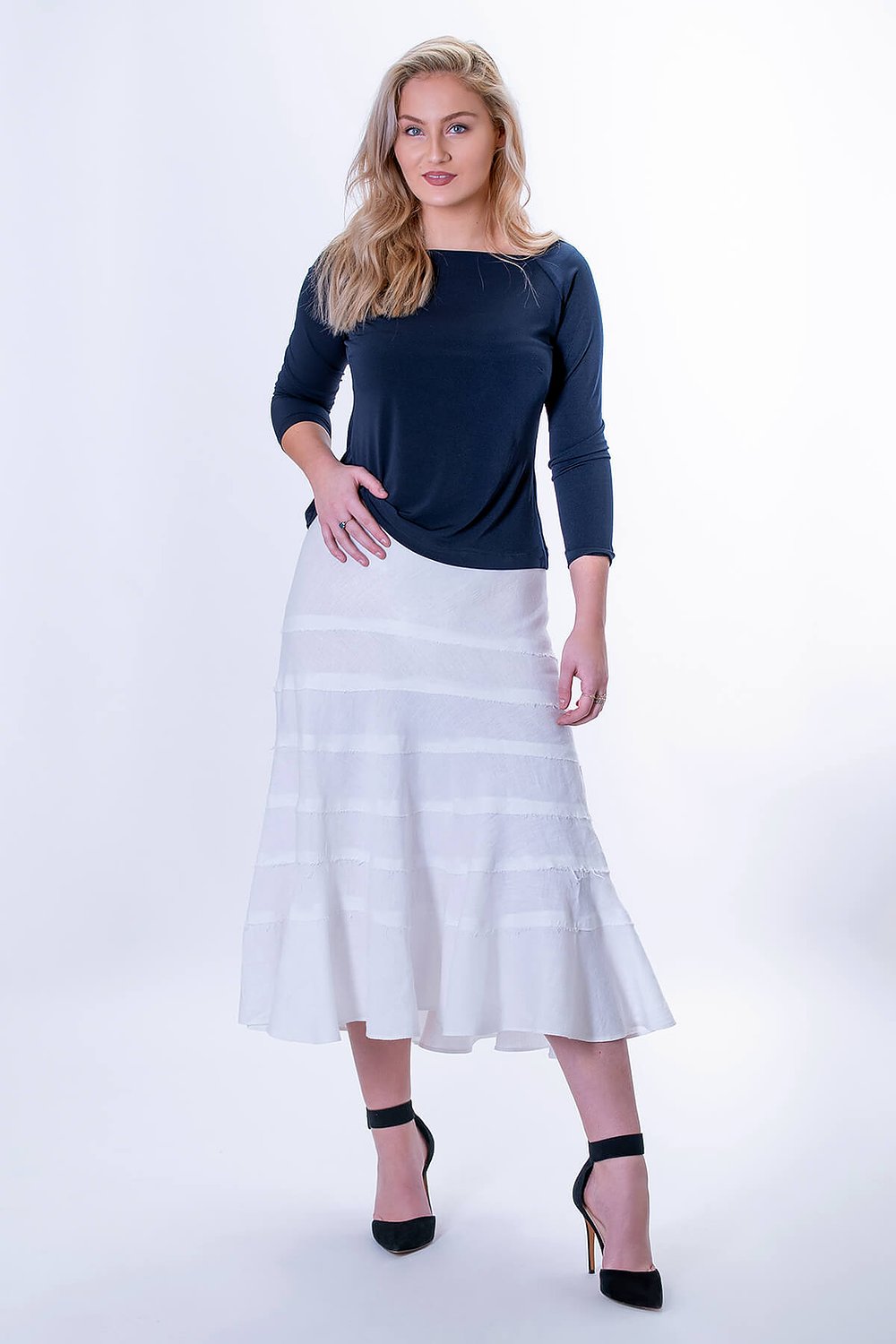 Women wearing the Sierra Tiered Bias Skirt sewing pattern from The Pattern Cutters on The Fold Line. A skirt pattern made in lightweight fabrics such as soft linen, featuring a midi-length, bias cut with multiple tiers, flared silhouette and elastic waist