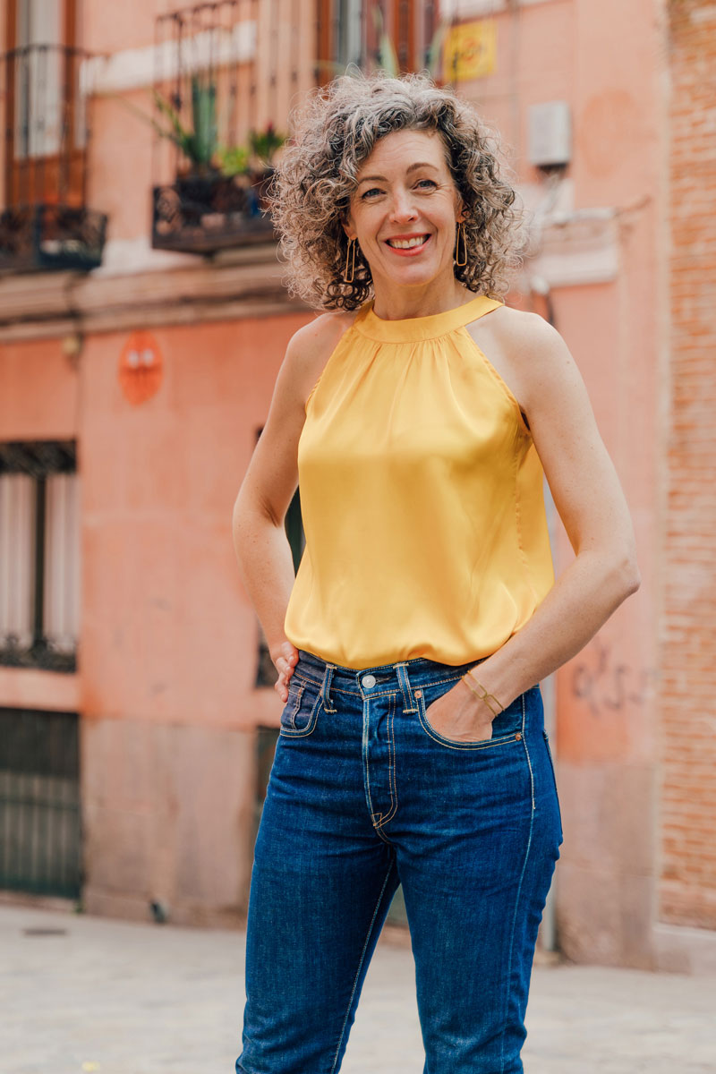 Woman wearing the Sintra Halter Top sewing pattern from Liesl + Co on The Fold Line. A sleeveless top pattern made in rayon, poly satin, silk satin and crepe fabrics, featuring a round halter neckband with gathered front, back button and buttonhole closur