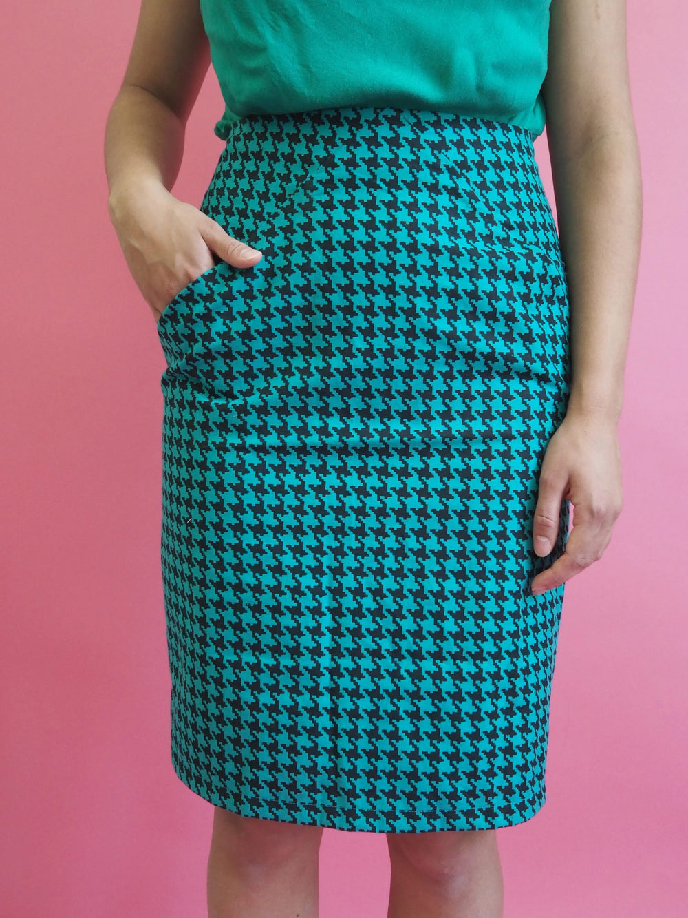 Woman wearing the Siv Skirt sewing pattern from Melilot on The Fold Line. A pencil skirt pattern made in mid-weight woven cotton or wool fabrics, featuring pockets hidden in diagonal seams at the front, darts, facings, an invisible zipper, and knee length