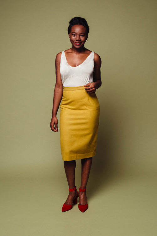 Woman wearing the Josephine Skirt sewing pattern from Melilot on The Fold Line. A pencil skirt pattern made in cotton, wool, suiting or jacquard/brocade fabrics, featuring a fitted silhouette, front and back waist darts, straight waistband, centre back zi