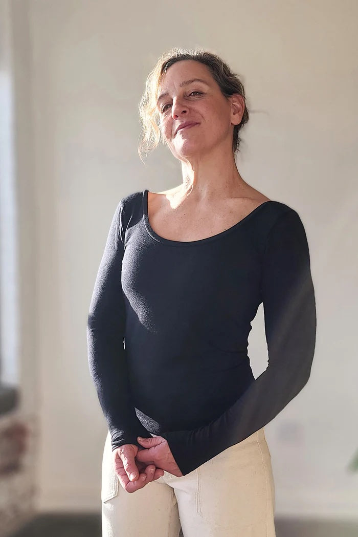 Woman wearing the Skyline Tee sewing pattern from Sew House Seven on The Fold Line. A T-shirt pattern made in stretch cotton jersey, stretch bamboo jersey and stretch baby French terry fabrics, featuring a body contouring fit, full-length sleeves, low sco