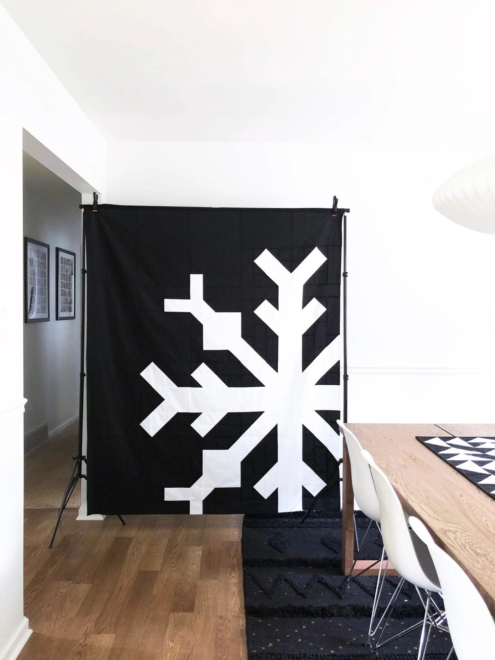 Photo showing the Snowflake Quilt sewing pattern from Modern Handcraft on The Fold Line. A quilt pattern made in quilting cotton fabrics, featuring a snowflake design, there are two ways to assemble this quilt. Use the larger block assembly style for a on