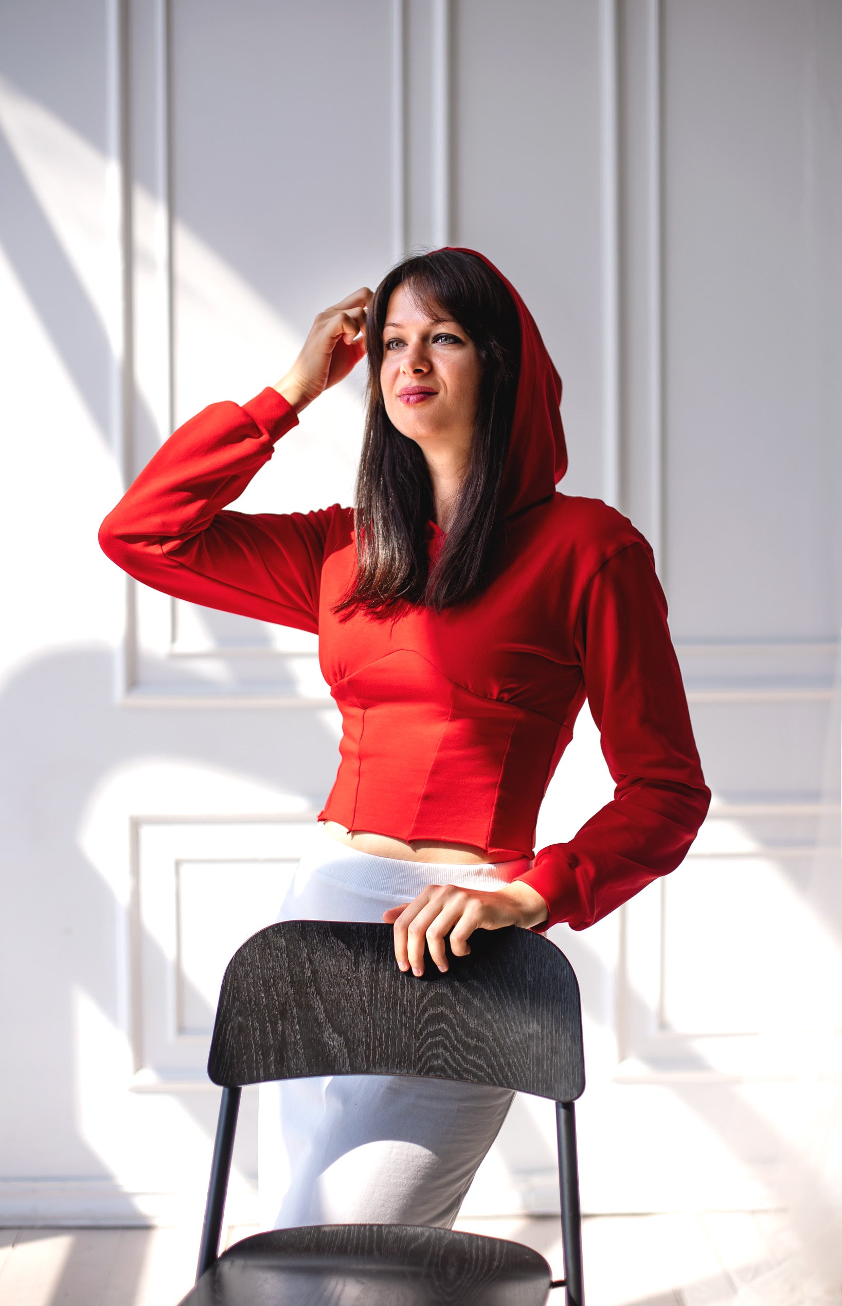 Women wearing the Sofie Hoodie sewing pattern from Kate’s Sewing Patterns on The Fold Line. A hoodie pattern made from jersey or French terry fabrics, featuring a fitted cropped silhouette, full length sleeves with cuffs, wide corset-style waistband and h
