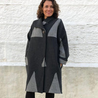 Woman wearing the Soho Coat sewing pattern from Tessuti Fabrics on The Fold Line. A coat pattern made in wool/cashmere blends, wool tweed, wool boucle and double wool crepe and heavy weight linen fabrics, featuring turn back collar, side pockets, dropped 