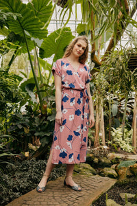 Woman wearing the Solange Dress sewing pattern from Atelier Jupe on The Fold Line. A dress pattern made in viscose or tencel fabrics, featuring a midi length, side slits, self-fabric belt, elasticated waist, back yoke with inverted pleat, V-neckline, shor