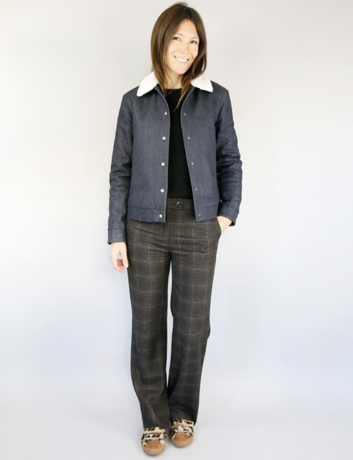 Woman wearing the Solstice Jacket sewing pattern from Atelier Scammit on The Fold Line. A jacket pattern made in medium to heavyweight wovens such as wool or jacquard fabrics, featuring slightly dropped shoulders, faux fur collar, high jetted pockets, ful