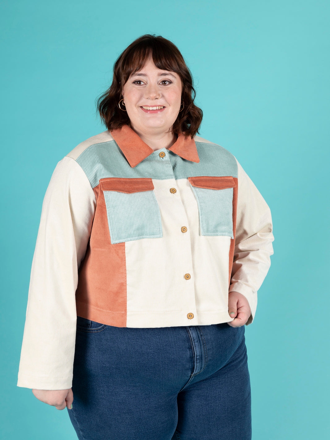 Woman wearing the Sonny Jacket sewing pattern from Tilly and the Buttons on Fold Line. A jacket pattern made in denim, twill, canvas, corduroy, jacquard or wool fabrics, featuring a boxy fit, drop shoulders, pointed collar, front and back yokes, chest poc