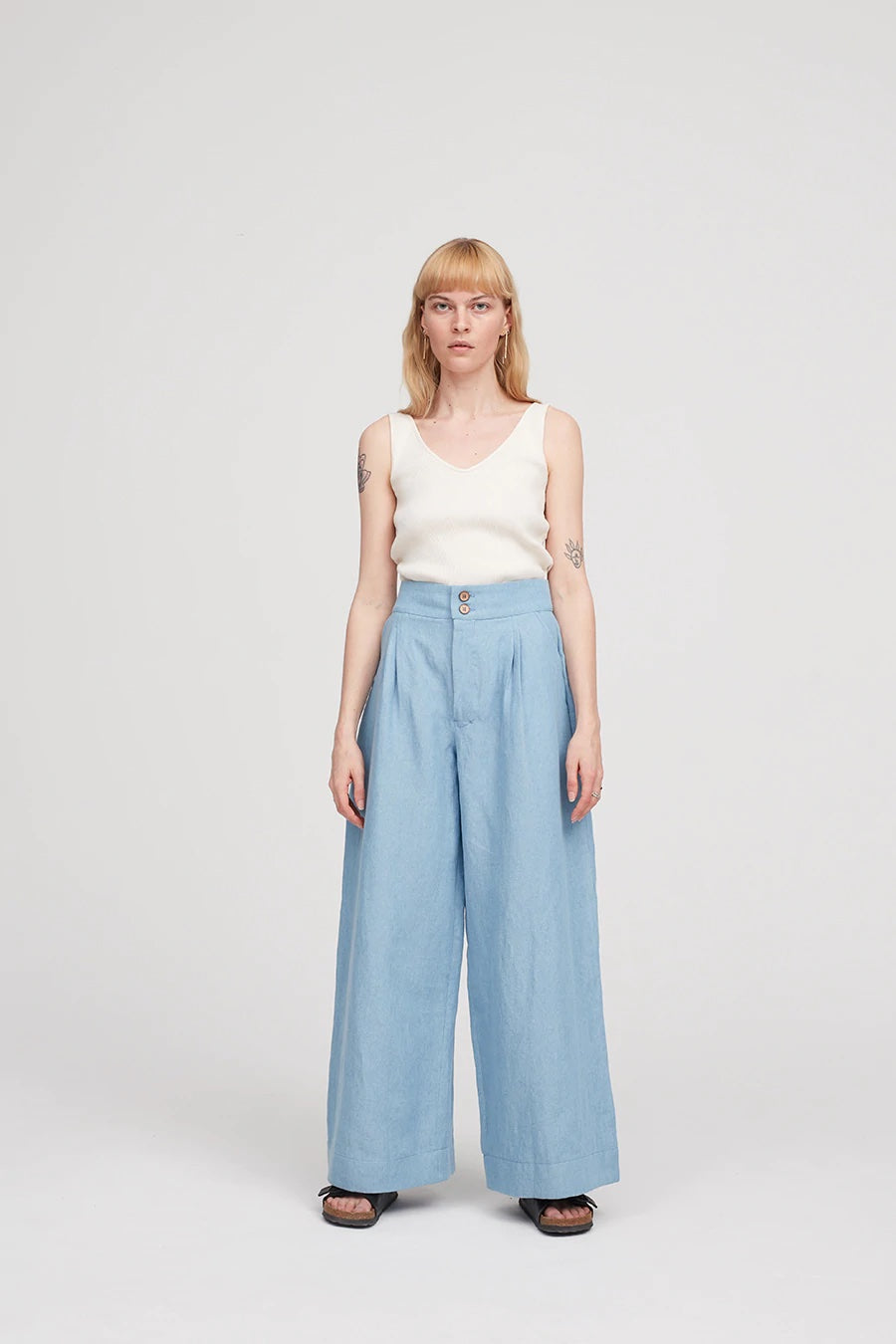 Woman wearing the Spring Trousers sewing pattern from The Modern Sewing Co on The Fold Line. A trouser pattern made in lightweight cottons, silk, Tencel twill or corduroy fabrics, featuring very wide legs, front pleats, semi-elasticated back, slanted side