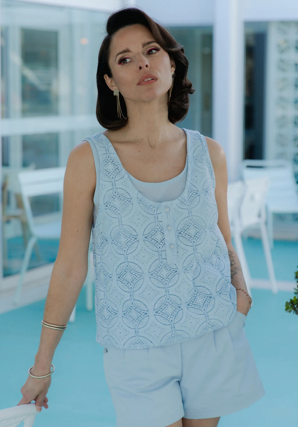 Woman wearing the Spritz Tank Top Duo sewing pattern from Maison Fauve on The Fold Line. A sleeveless top pattern made in fine jacquard, twill, crepe, poplin, voile, lace, cotton, viscose, or silk fabric, featuring two tank tops, one with a button placket