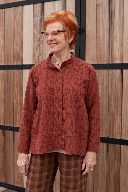 Woman wearing the Sterling Jacket sewing pattern from The Sewing Workshop on The Fold Line. A jacket pattern made in linen, cotton, silk, wool, rayon or knit fabrics, featuring a button-front with button plackets, side panels, bias flounce and stand-up do