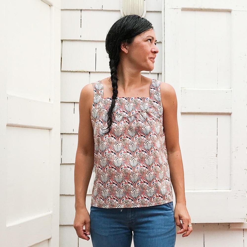 Woman wearing the Strand Top pattern from Halfmoon Atelier on The Fold Line. A sleeveless top pattern made in cotton, lawn, double gauze, linen, silk or fabrics, featuring broad shoulder straps, square neckline, straight silhouette and gathered yolk front