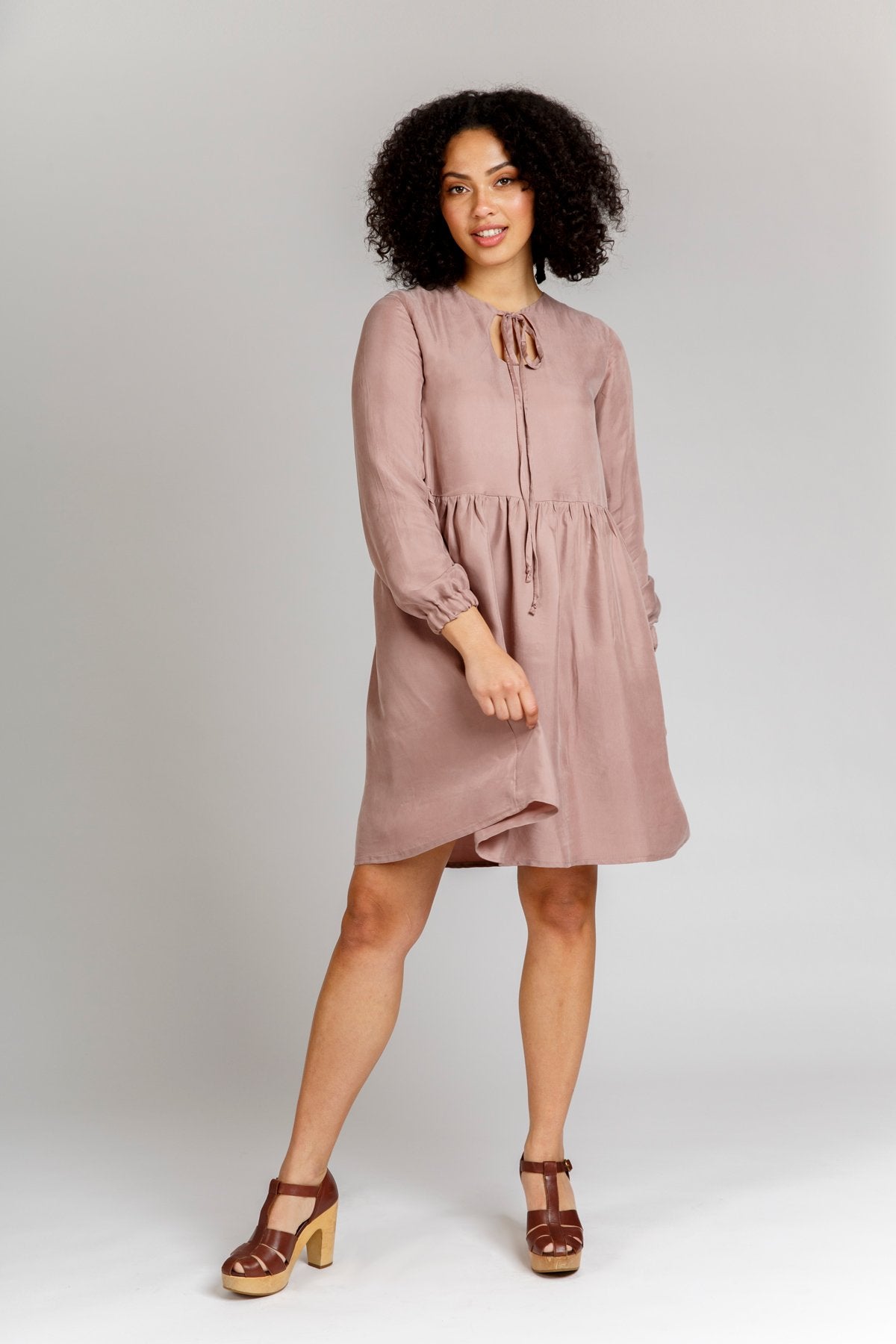 Woman wearing the Sudley Dress sewing pattern from Megan Nielsen on The Fold Line. A dress pattern made in crepe de chine, cotton, voile, batiste, crepe, lawn, silk charmeuse, georgette, challis, rayon, linen and chambray fabrics, featuring a reversible s